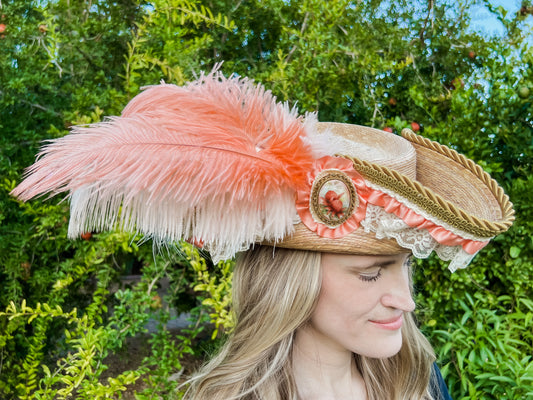 Tricorn Hat 20.5" Beige Straw Base with Peach Trim, Feathers, and Gold Brooch