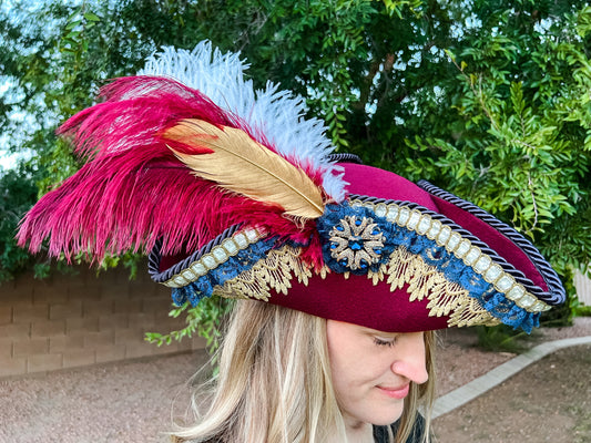 Tricorn Hat 21.75" Maroon Polyester Base with Gold/Navy Trim, Feathers, and Brooch