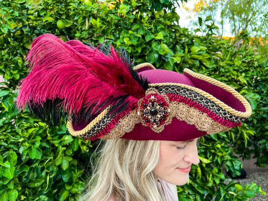 Tricorn Hat 21.75" Maroon Polyester Base with Gold Trim, Feathers, and Maltese Brooch