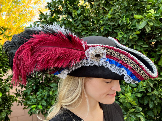 Tricorn Hat 22" Black Polyester Base with Maroon/Blue Trim, Feathers, and Silver Brooch