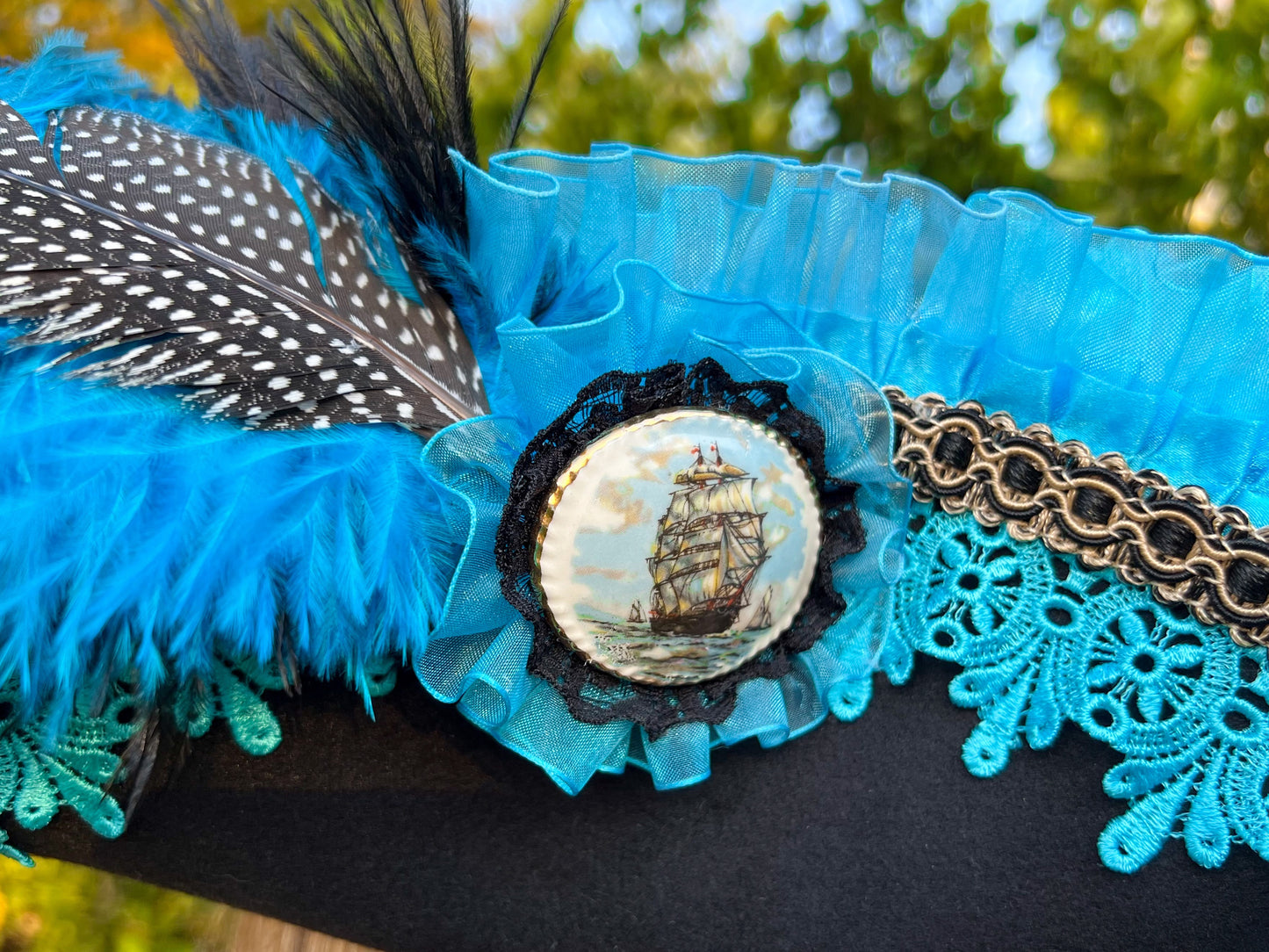 Tricorn Hat 22" Black Polyester Base with Turquoise Trim, Feathers, and Ship Brooch