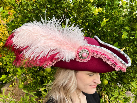 Tricorn Hat 22" Maroon Polyester Base with Pink Trim, Feathers, and Silver Brooch