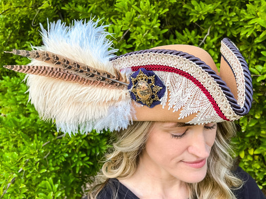 Tricorn Hat 22" Tan Polyester Base with Navy/Red/White Trim, Feathers, and Brooch