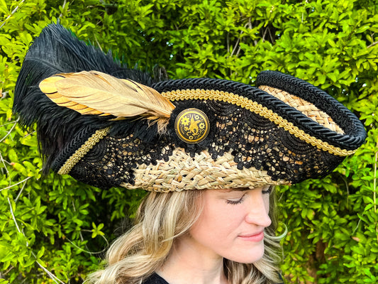 Tricorn Hat 22.5" Beige Straw Base with Black/Gold Trim, Feathers, and Brooch